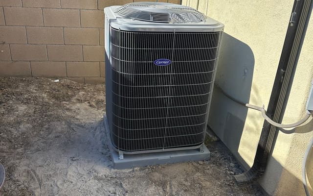 Carrier air conditioning condenser installed beside a Los Angeles home