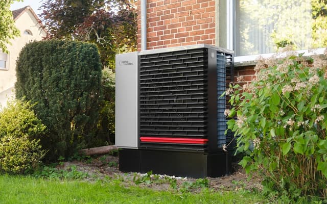 Outdoor heat pump unit beside a home